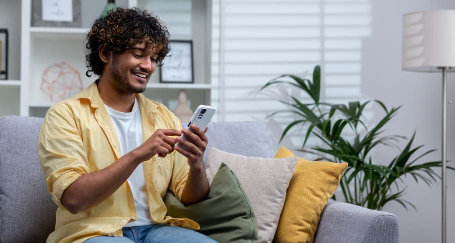Resident accessing a home security app on his smartphone