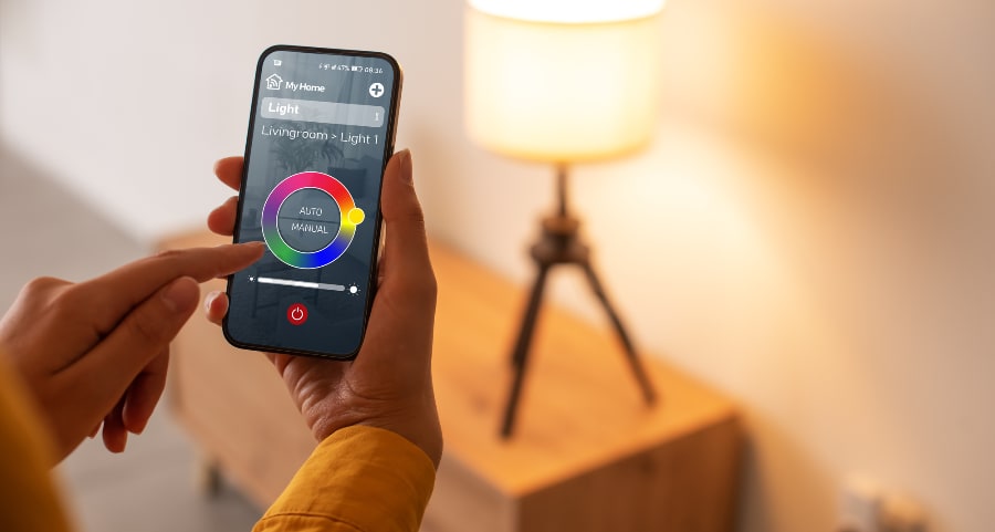 Person adjusting a smart light through an app on their phone
